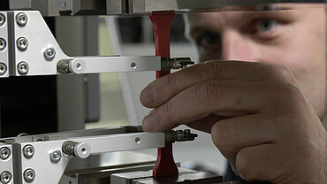 成形材料の試験における伸び計を使用した引張試験片の詳細なビュー - ASTM D638 引張特性